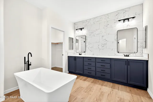 a bathroom with a bathtub sink and mirror