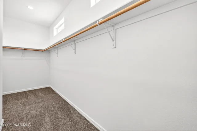 an empty room with a ceiling fan and window