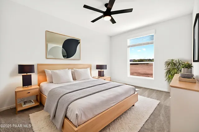 an empty room with closet and a ceiling fan