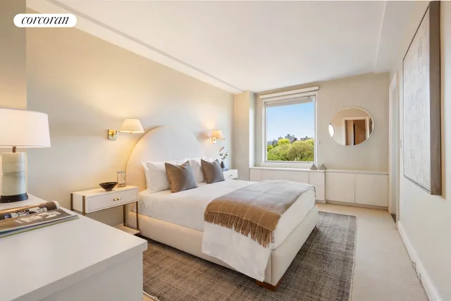 a bedroom with two beds and a window