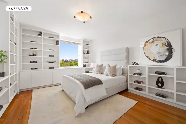 a bedroom with a bed and a bookshelf with wooden floor