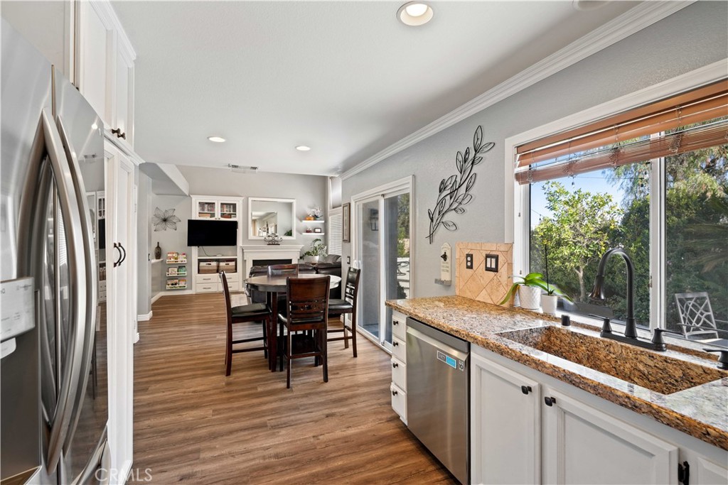 25510 Chisom Lane Stevenson Ranch, CA 91381 - Photo 16 of 53 a kitchen with stainless steel appliances granite countertop sink microwave and wooden floor