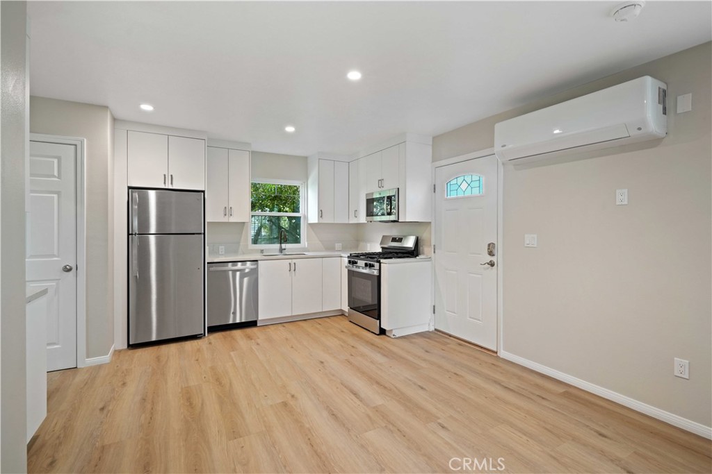 25510 Chisom Lane Stevenson Ranch, CA 91381 - Photo 35 of 53 a kitchen with white cabinets and stainless steel appliances
