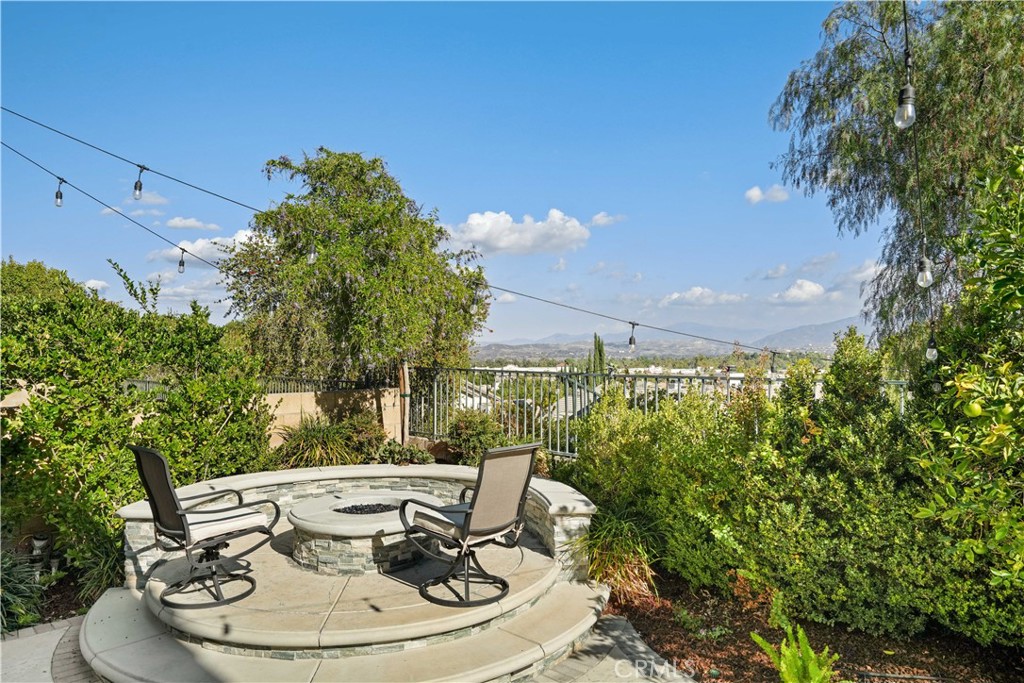 25510 Chisom Lane Stevenson Ranch, CA 91381 - Photo 43 of 53 a backyard of a house with table and chairs plants and large tree
