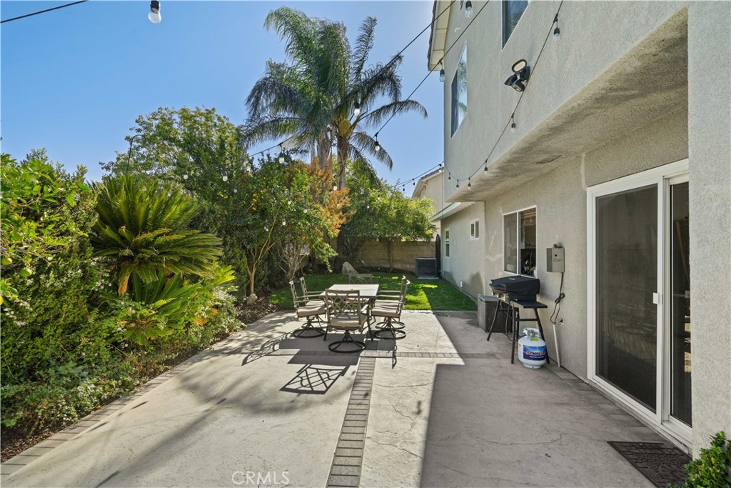 25510 Chisom Lane Stevenson Ranch, CA 91381 - Photo 48 of 53 a view of a patio with table and chairs and potted plants