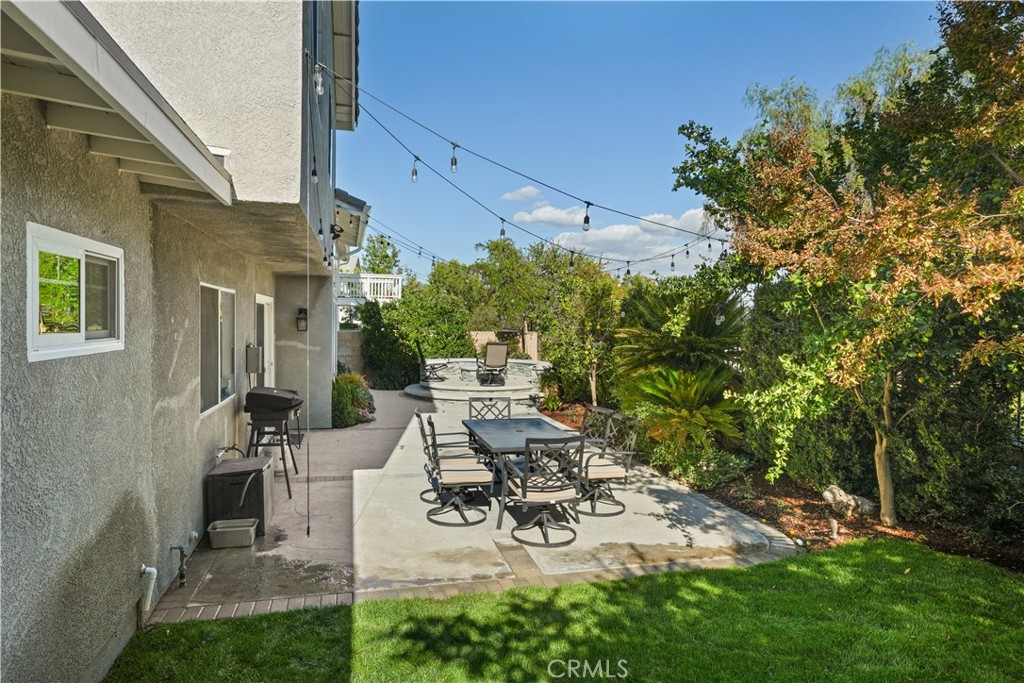 25510 Chisom Lane Stevenson Ranch, CA 91381 - Photo 50 of 53 a view of a patio with table and chairs and potted plants