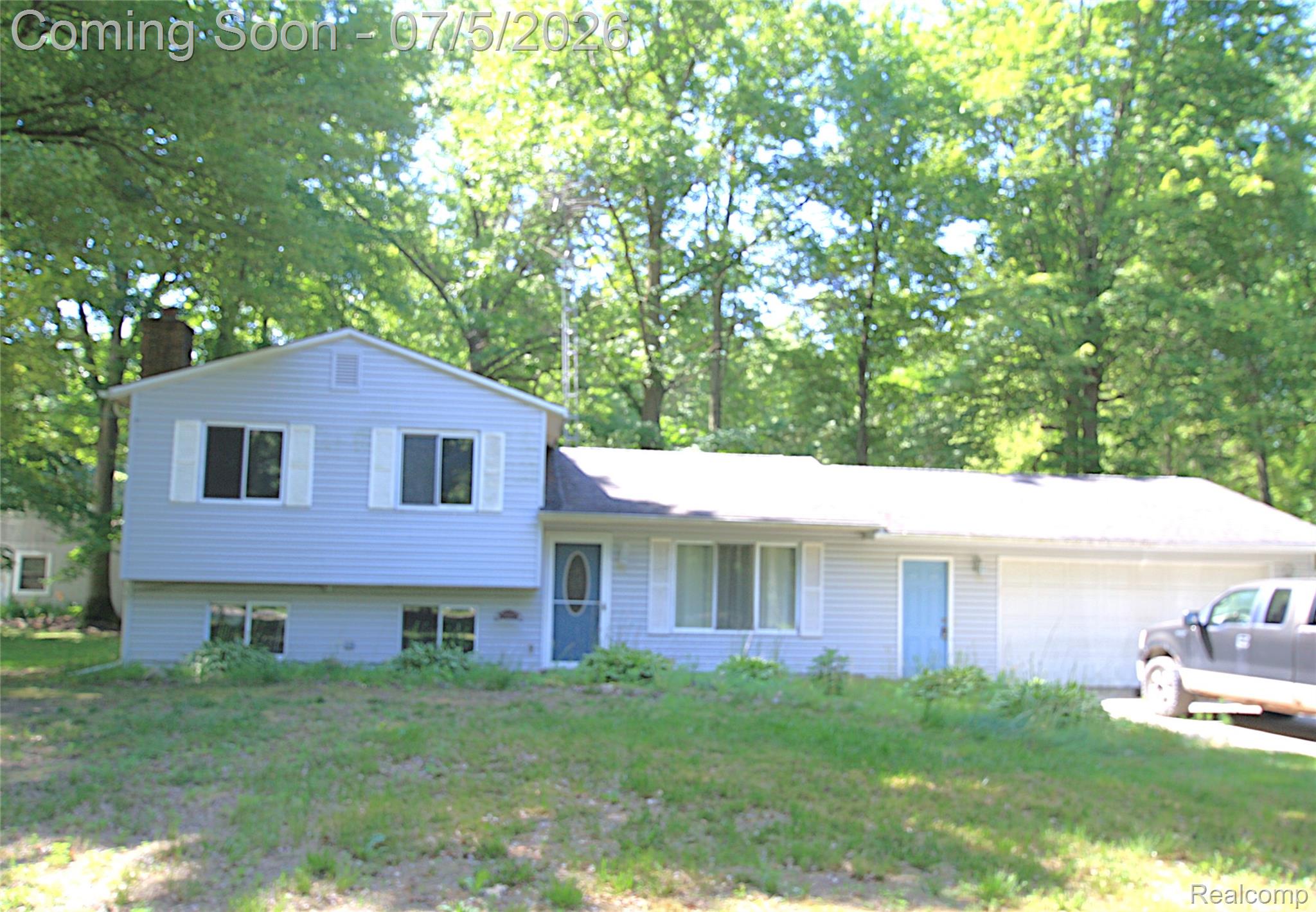 12403 Willard Road Montrose, MI 48457 - Photo 3 of 30 Split-level residence featuring light blue siding with white trim