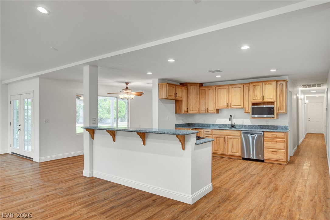 1810 Pinto Road Henderson, NV 89002 - Photo 18 of 53 Bright open-concept kitchen and living area, with natural wood cabinetry and modern amenities.
