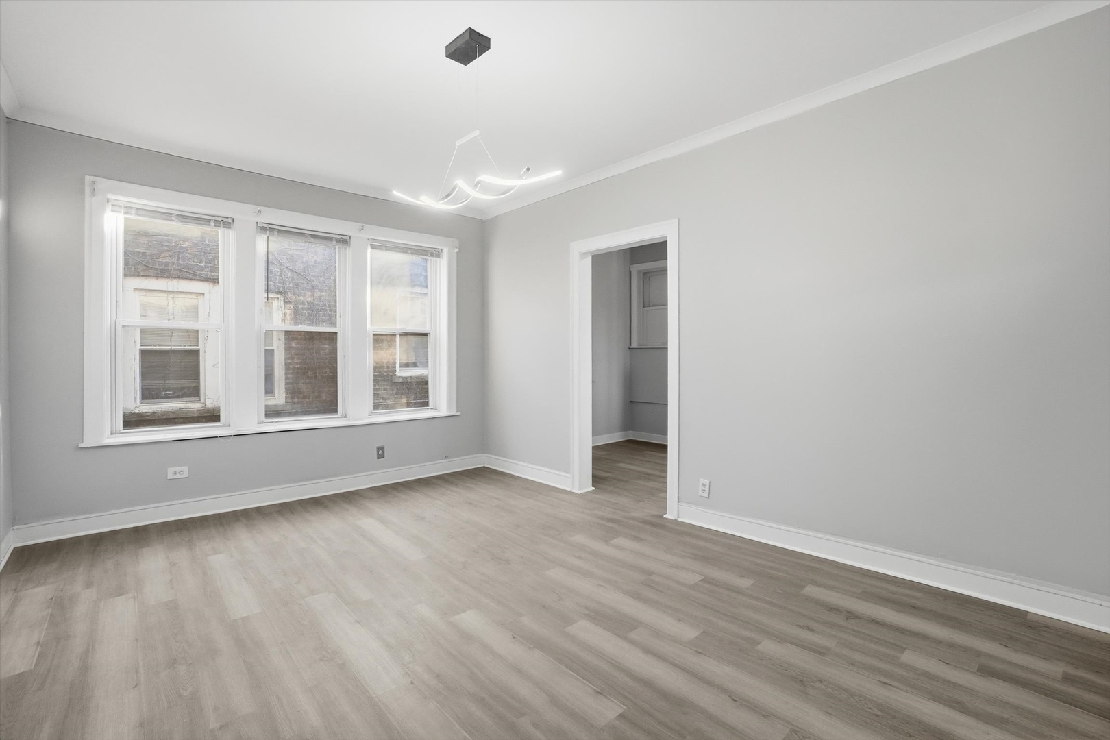 8434 South Drexel Avenue Chicago, IL 60619 - Photo 14 of 19 wooden floor in an empty room with a window