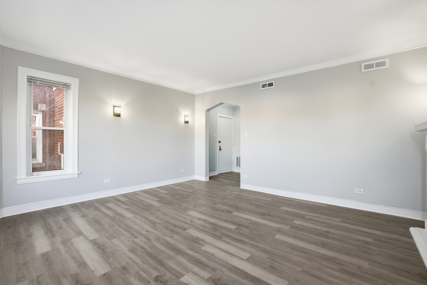 8434 South Drexel Avenue Chicago, IL 60619 - Photo 4 of 19 a view of an empty room with wooden floor and a window
