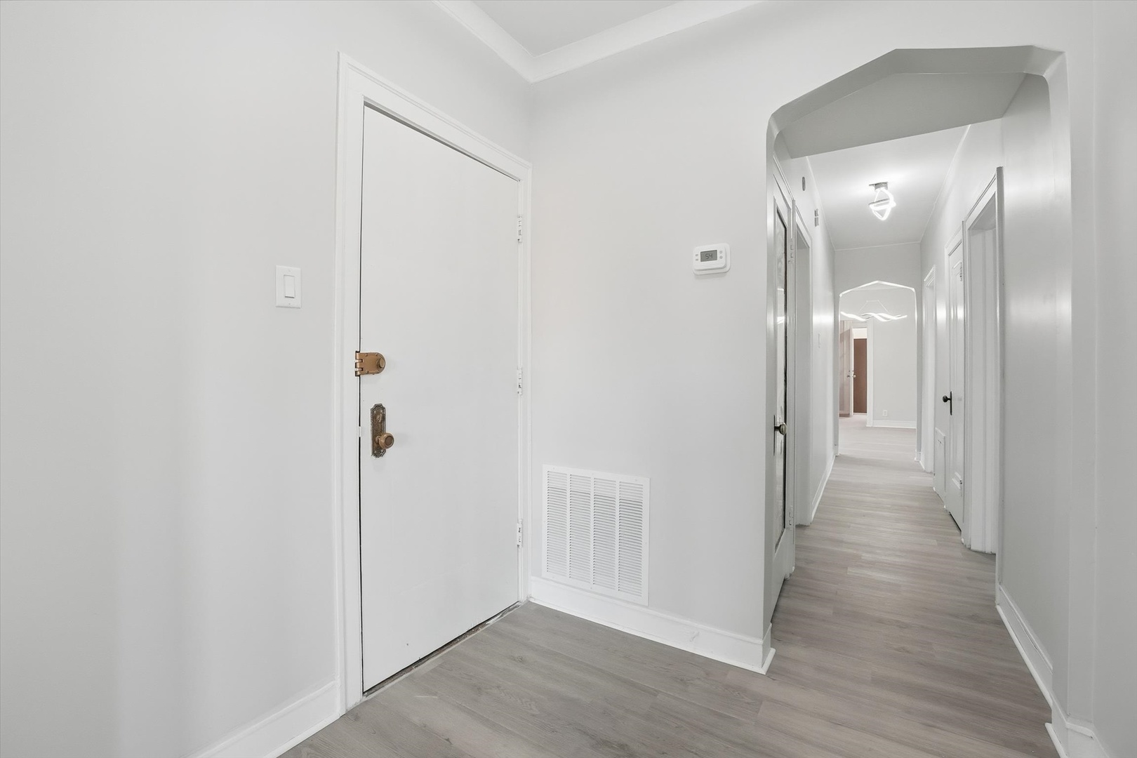 8434 South Drexel Avenue Chicago, IL 60619 - Photo 5 of 19 a view of a hallway with wooden floor