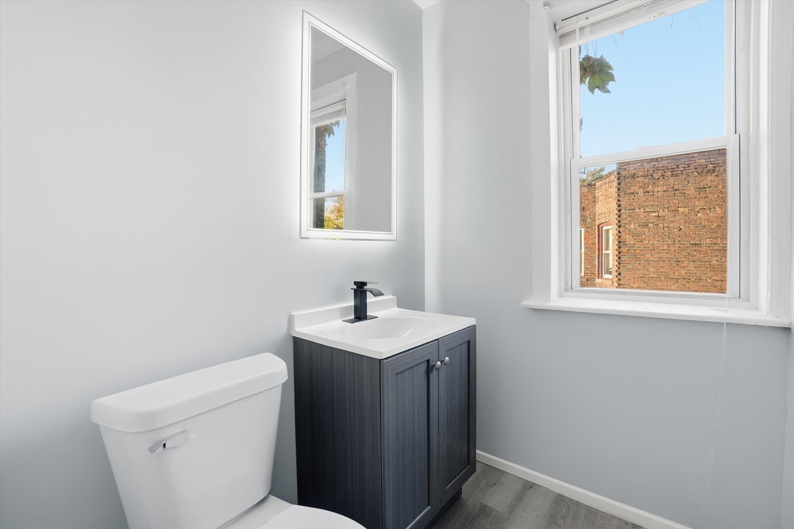 8434 South Drexel Avenue Chicago, IL 60619 - Photo 6 of 19 a bathroom with a toilet sink and mirror