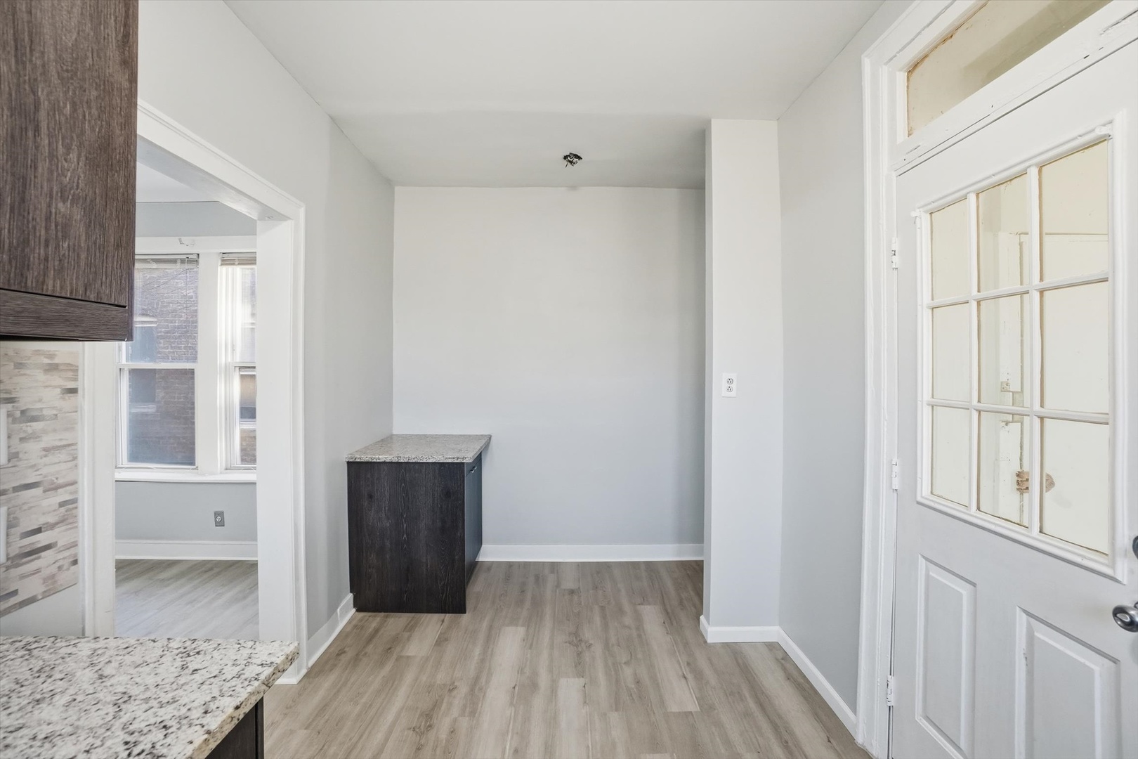 8434 South Drexel Avenue Chicago, IL 60619 - Photo 9 of 19 a view of a room with wooden floor and cabinet