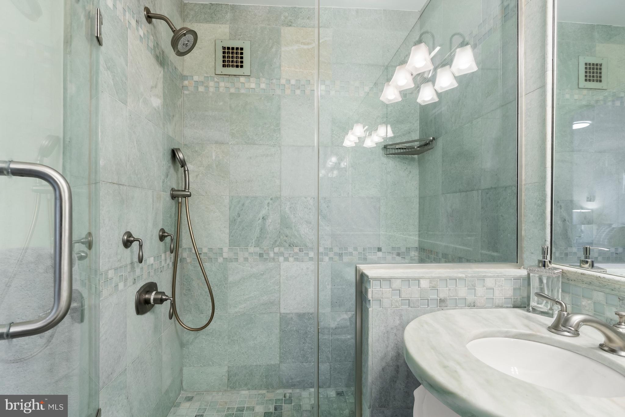 4000 Tunlaw Road Northwest, Unit 1007 Washington, DC 20007 - Photo 22 of 50 a bathroom with a sink shower and a mirror