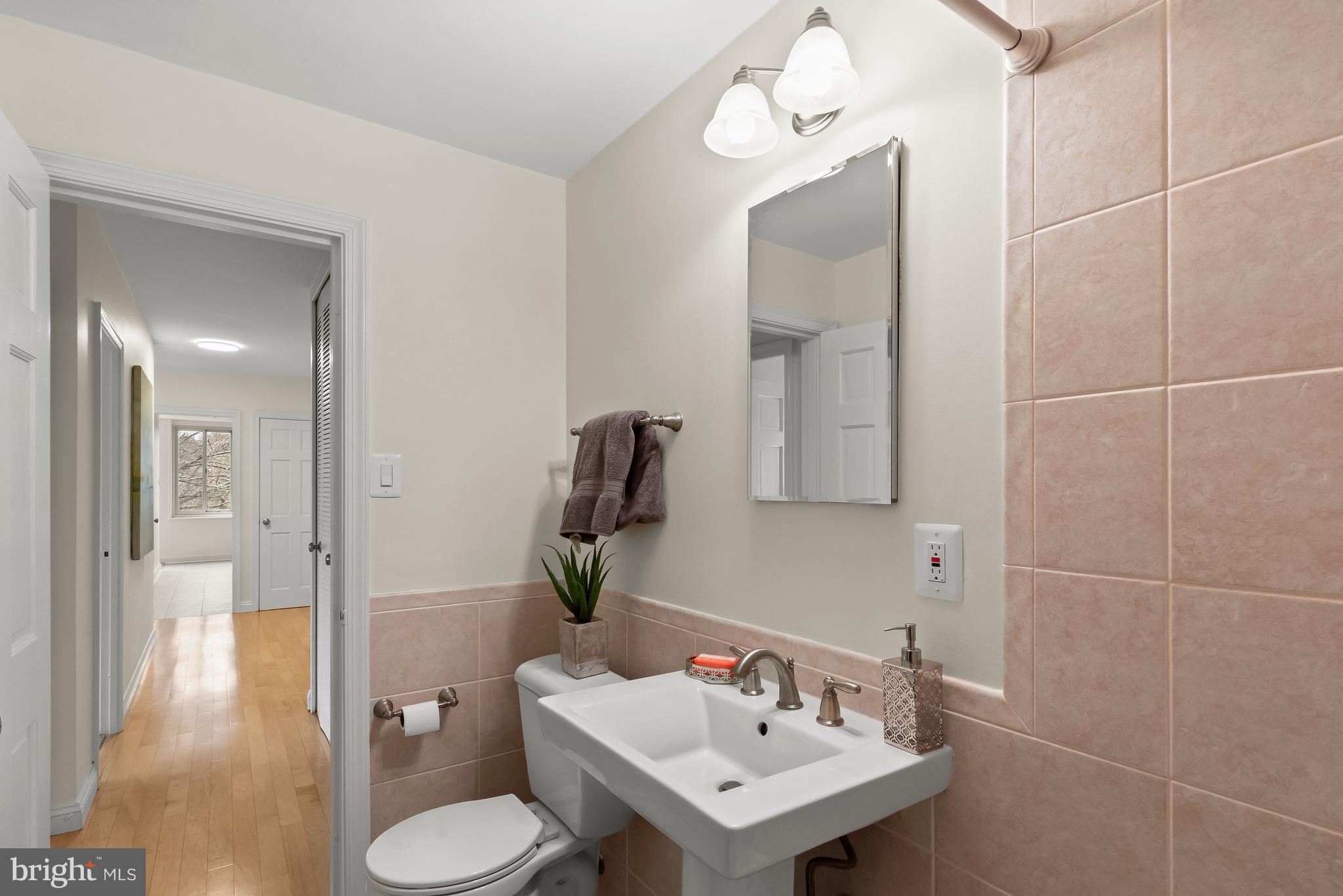 4000 Tunlaw Road Northwest, Unit 1007 Washington, DC 20007 - Photo 27 of 50 a bathroom with a sink toilet and shower