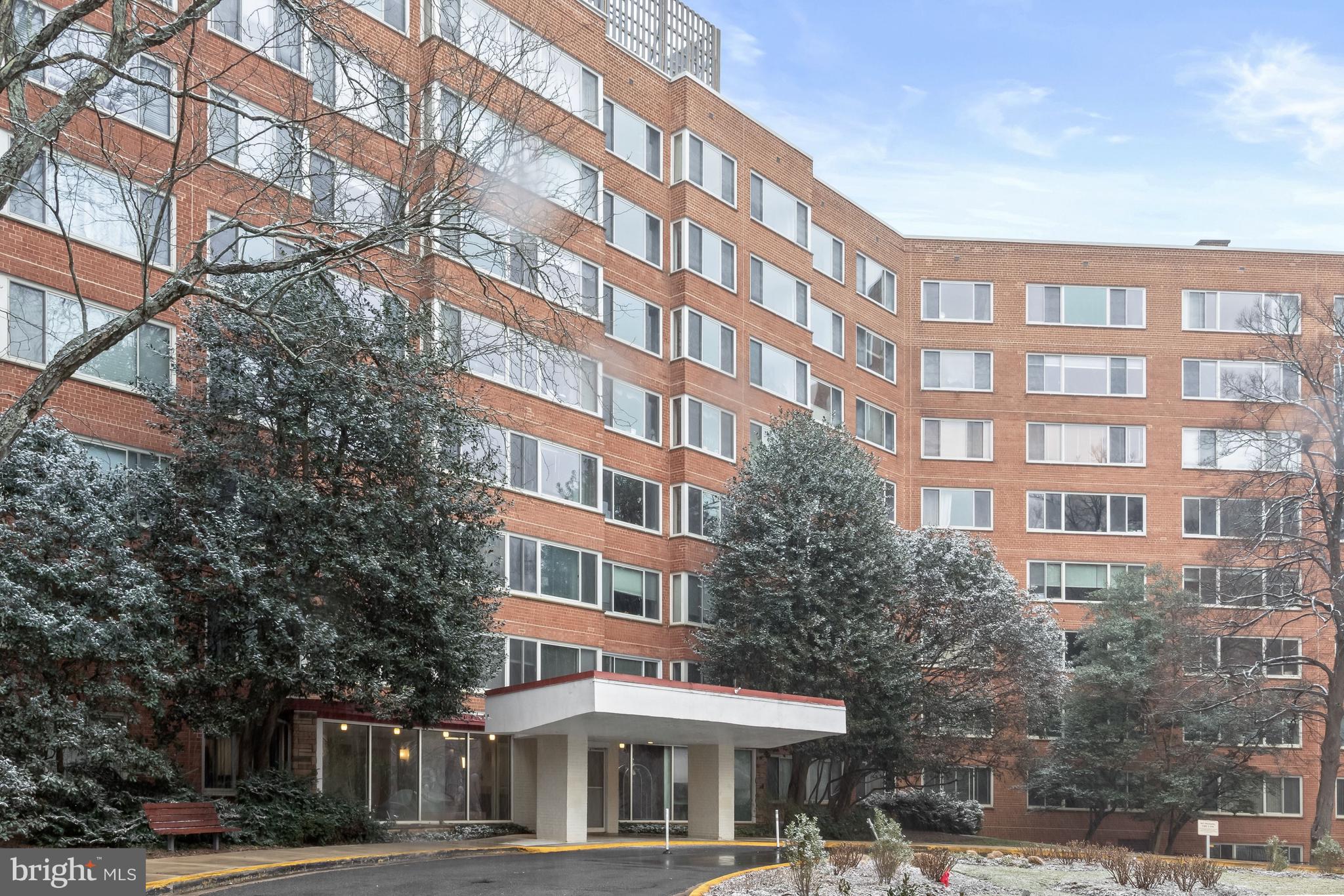 4000 Tunlaw Road Northwest, Unit 1007 Washington, DC 20007 - Photo 47 of 50 a front view of a building with lot of trees and retail shops