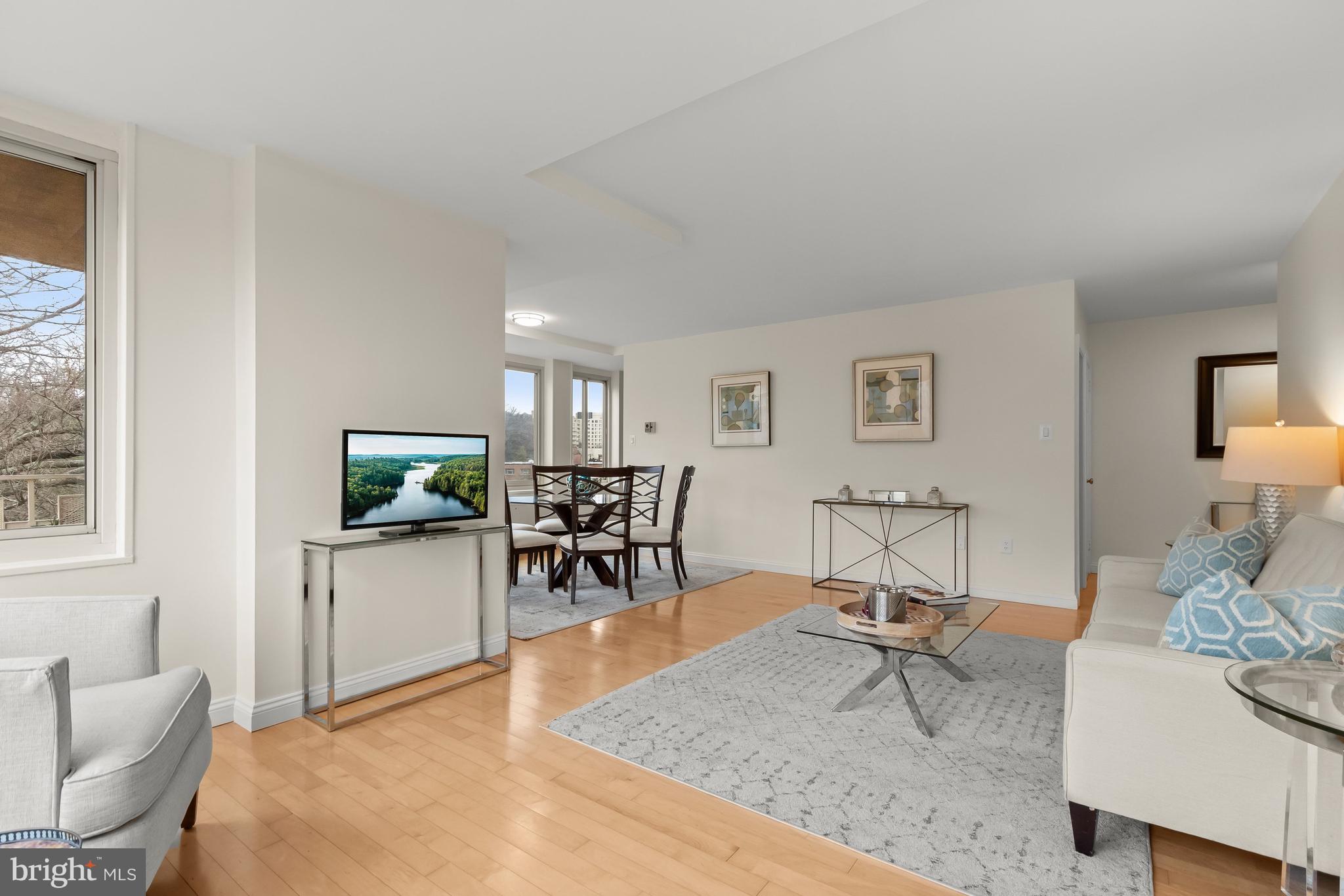 4000 Tunlaw Road Northwest, Unit 1007 Washington, DC 20007 - Photo 4 of 50 a living room with furniture a flat screen tv and a window