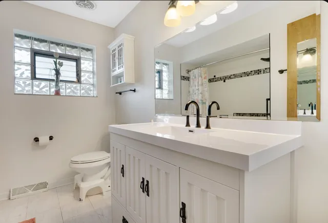 a bathroom with a bath tub with a shower