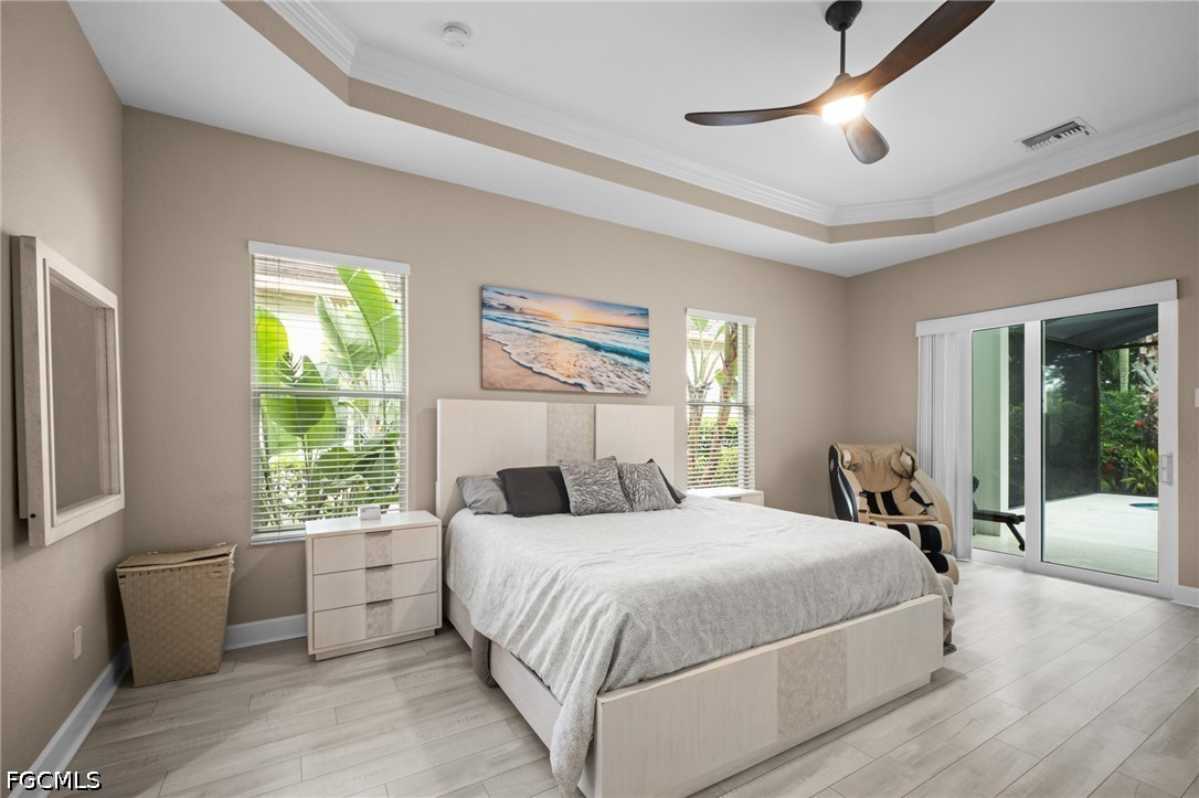 9042 Bronco Court Naples, FL 34113 - Photo 15 of 50 a bedroom with a large bed and a large window with outer view