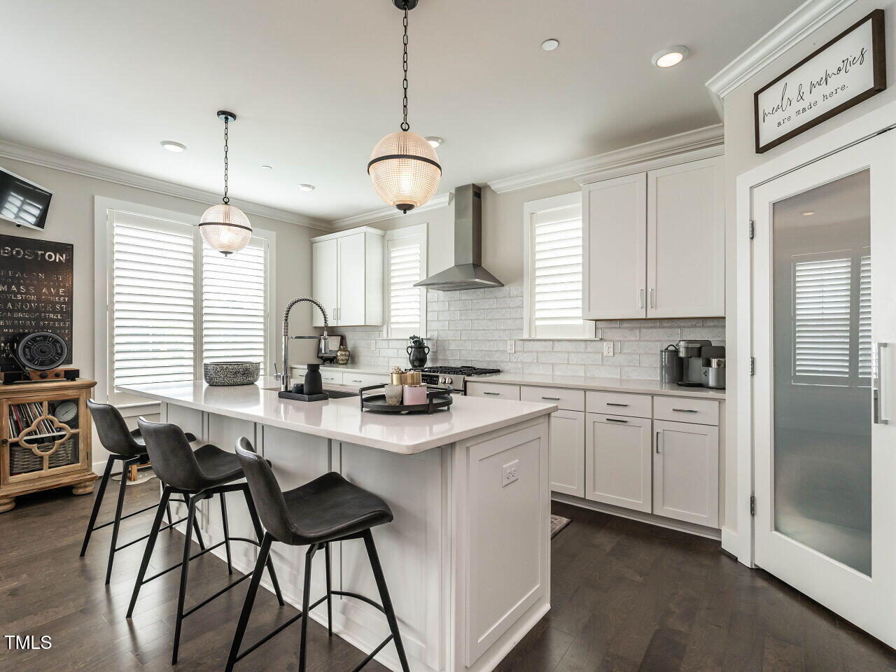 1610 Draper View Loop, Unit 101 Raleigh, NC 27608 - Photo 16 of 39 a kitchen with stainless steel appliances granite countertop a sink a stove a refrigerator a center island and a window
