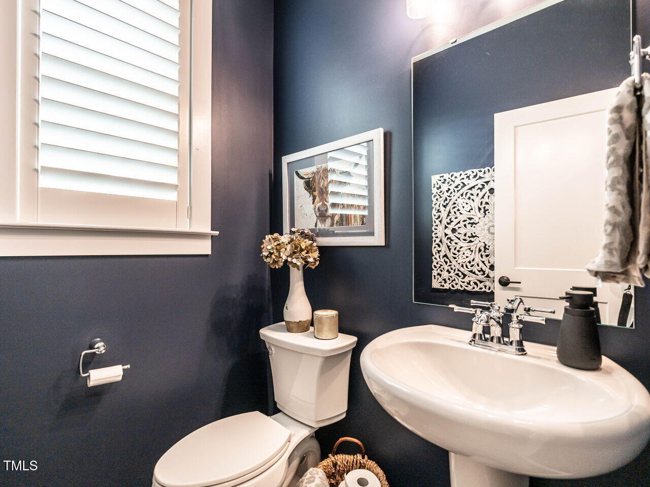 1610 Draper View Loop, Unit 101 Raleigh, NC 27608 - Photo 19 of 39 a bathroom with a sink a toilet and a mirror
