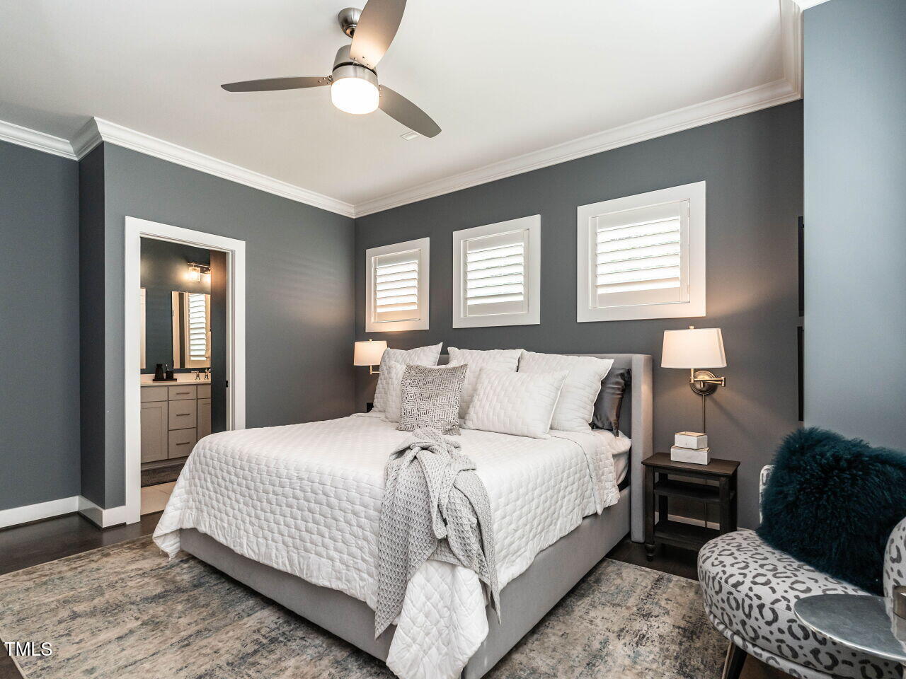 1610 Draper View Loop, Unit 101 Raleigh, NC 27608 - Photo 21 of 39 a bedroom with a bed couch and a chandelier