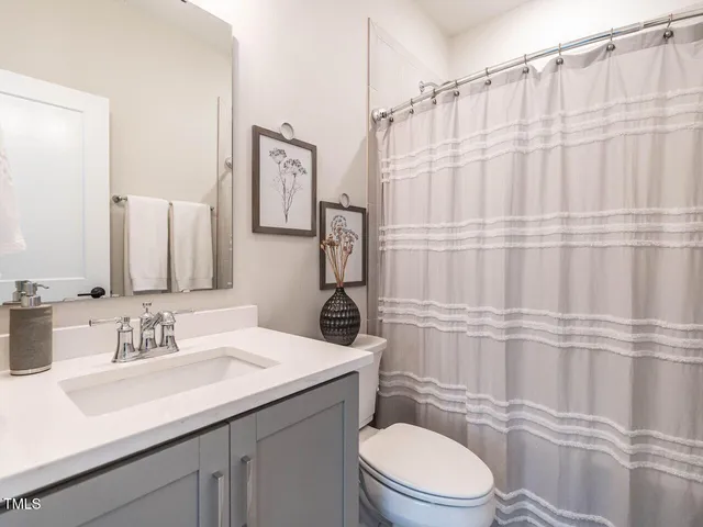 a large bed sitting in a bedroom next to a window