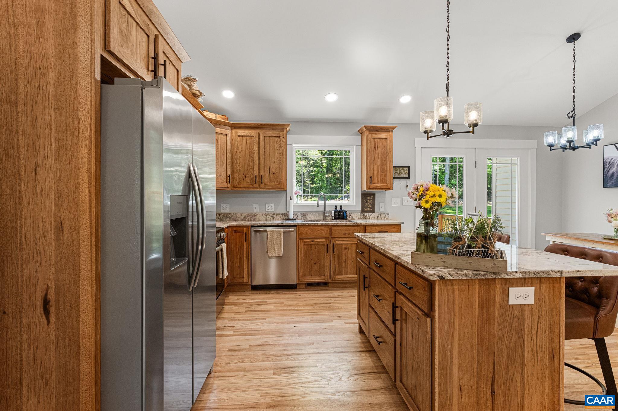 230 Fox Hollow Road Ruckersville, VA 22968 - Photo 11 of 42 a kitchen with kitchen island granite countertop a sink a counter top space stainless steel appliances and cabinets