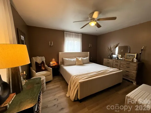a bedroom with bed and a chandelier