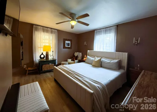 a bedroom with double bed and a flat tv screen