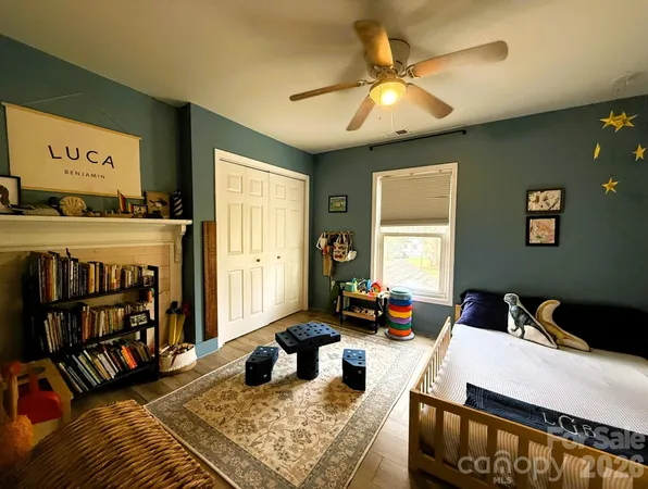 a living room with lots of furniture and baby bed