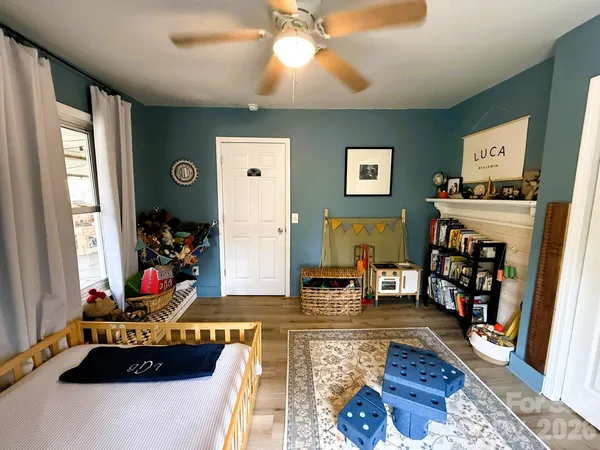a bed room with a bed furniture and a flat screen tv