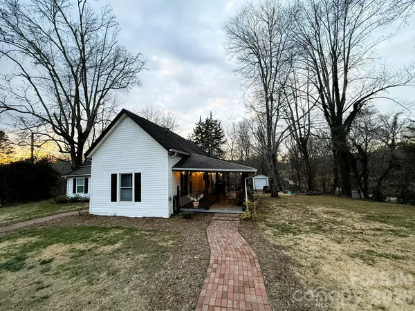 a view of a house with a yard covered in snow