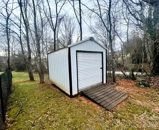 a view of a house with a yard covered in snow