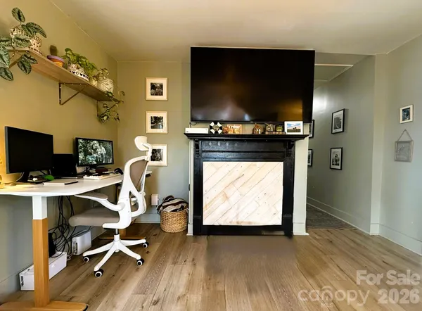 a view of a workspace with furniture and a flat screen tv