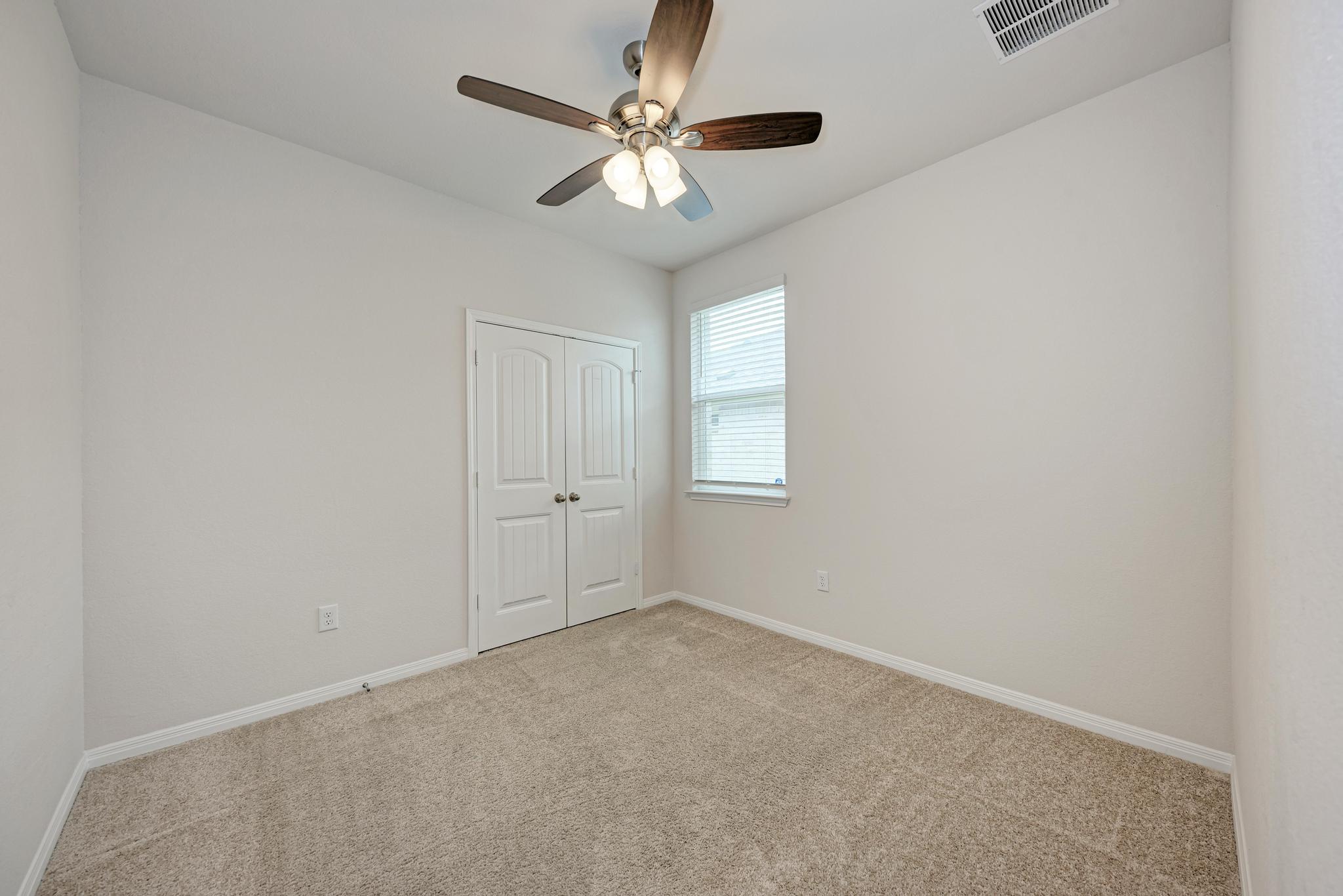 208 Abby Road Georgetown, TX 78626 - Photo 31 of 40 an empty room with windows and fan