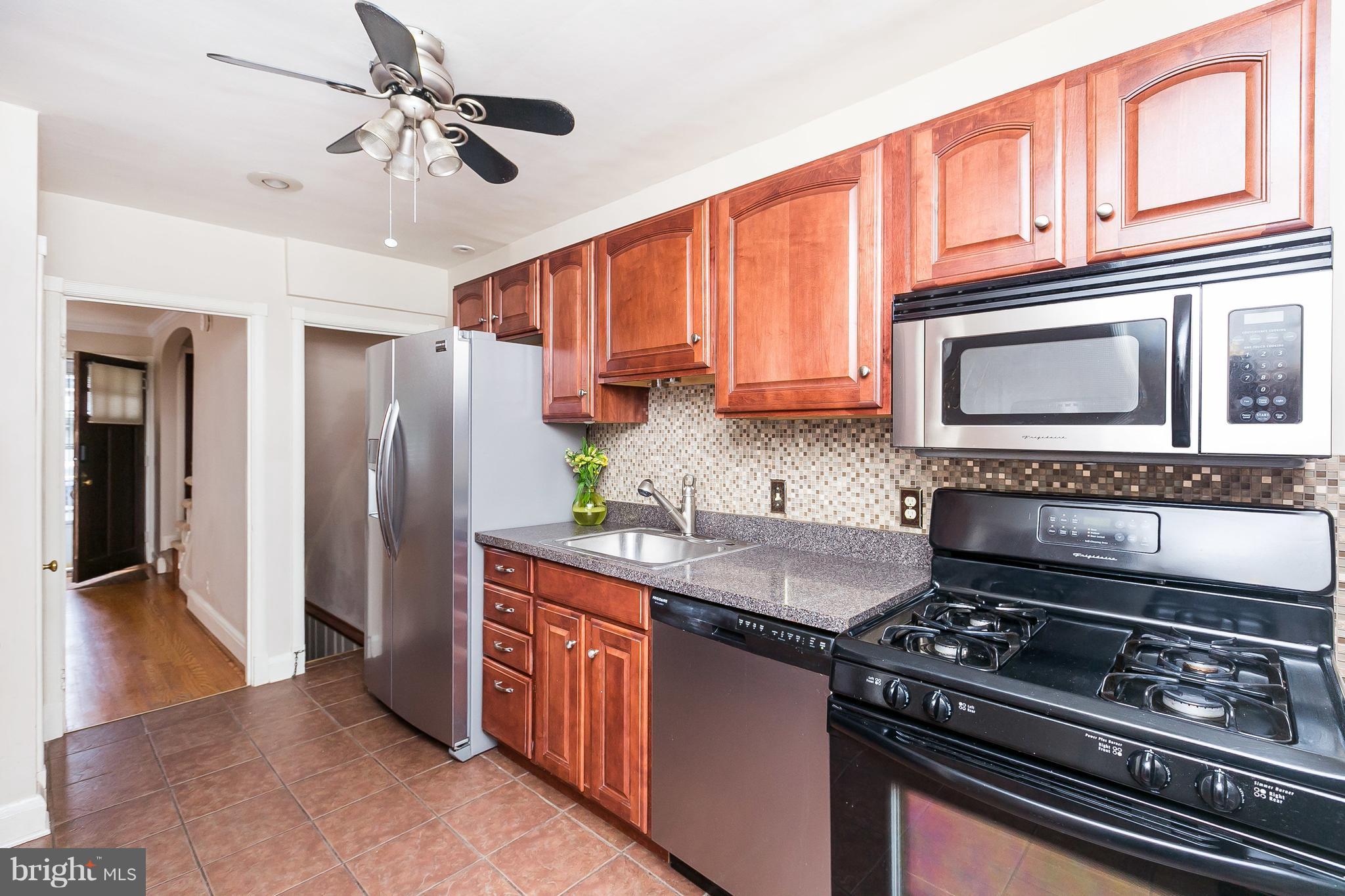 39 Murdock Road Baltimore, MD 21212 - Photo 11 of 28 a kitchen with stainless steel appliances granite countertop a stove top oven a refrigerator a sink and dishwasher