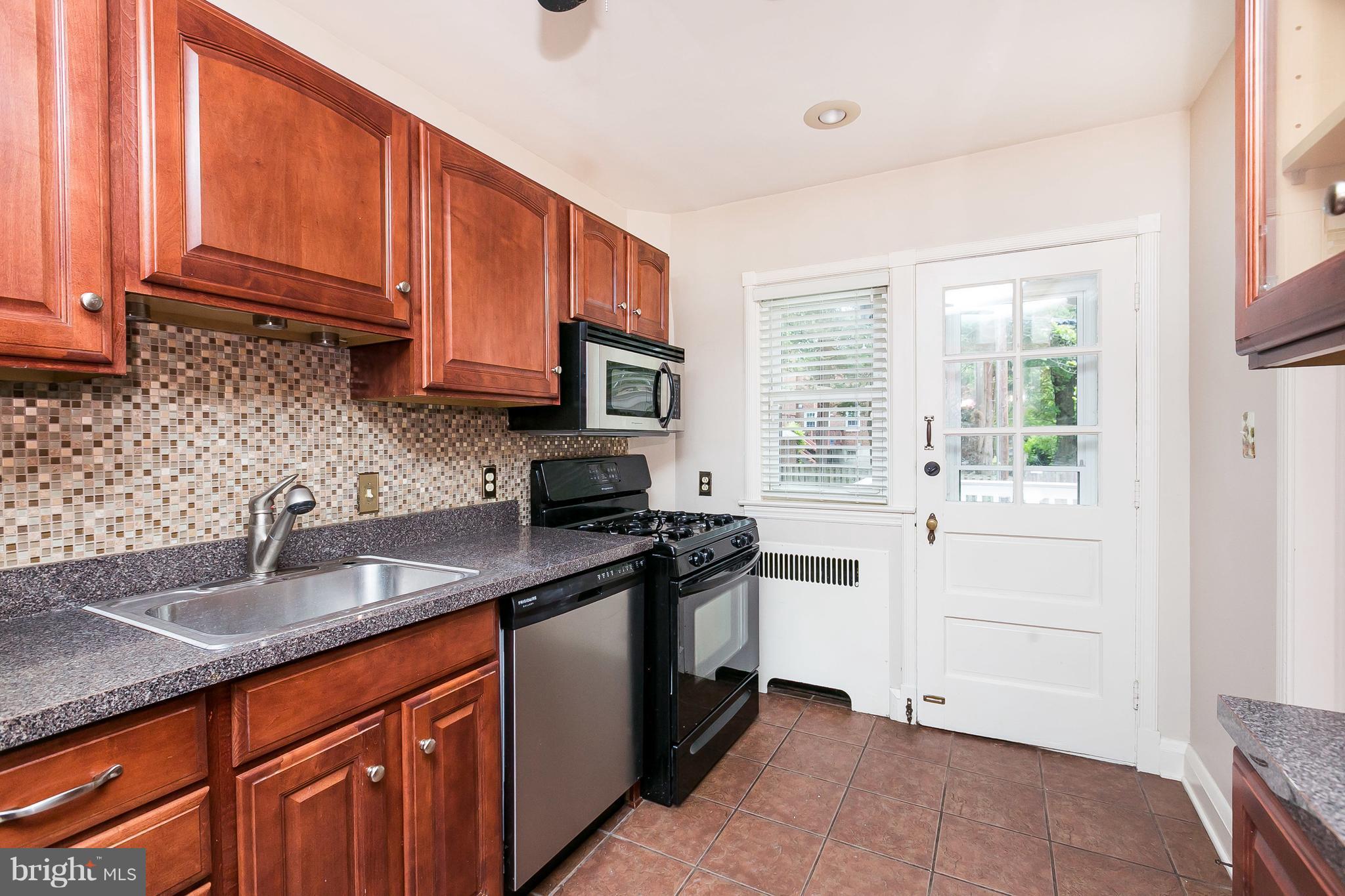39 Murdock Road Baltimore, MD 21212 - Photo 13 of 28 a kitchen with stainless steel appliances granite countertop a sink stove and cabinets