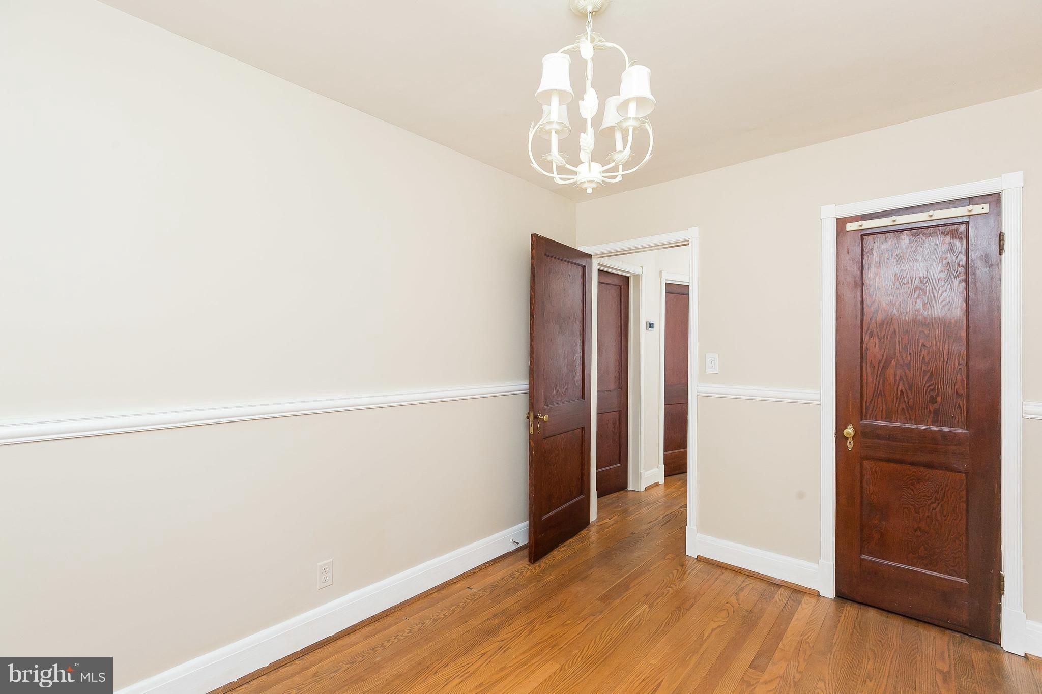 39 Murdock Road Baltimore, MD 21212 - Photo 15 of 28 wooden floor in an empty room with a chandelier