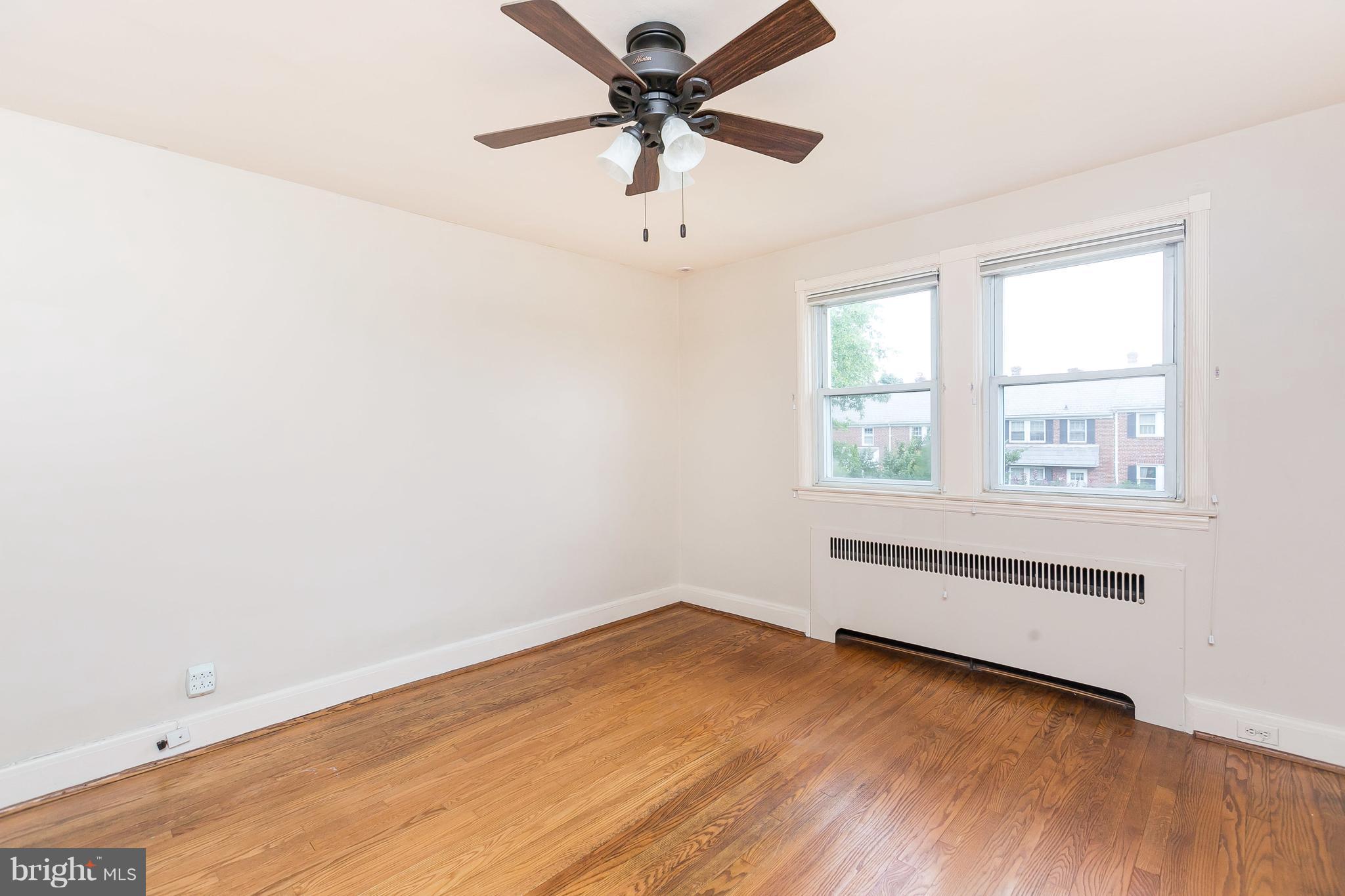 39 Murdock Road Baltimore, MD 21212 - Photo 18 of 28 an empty room with wooden floor fan and windows