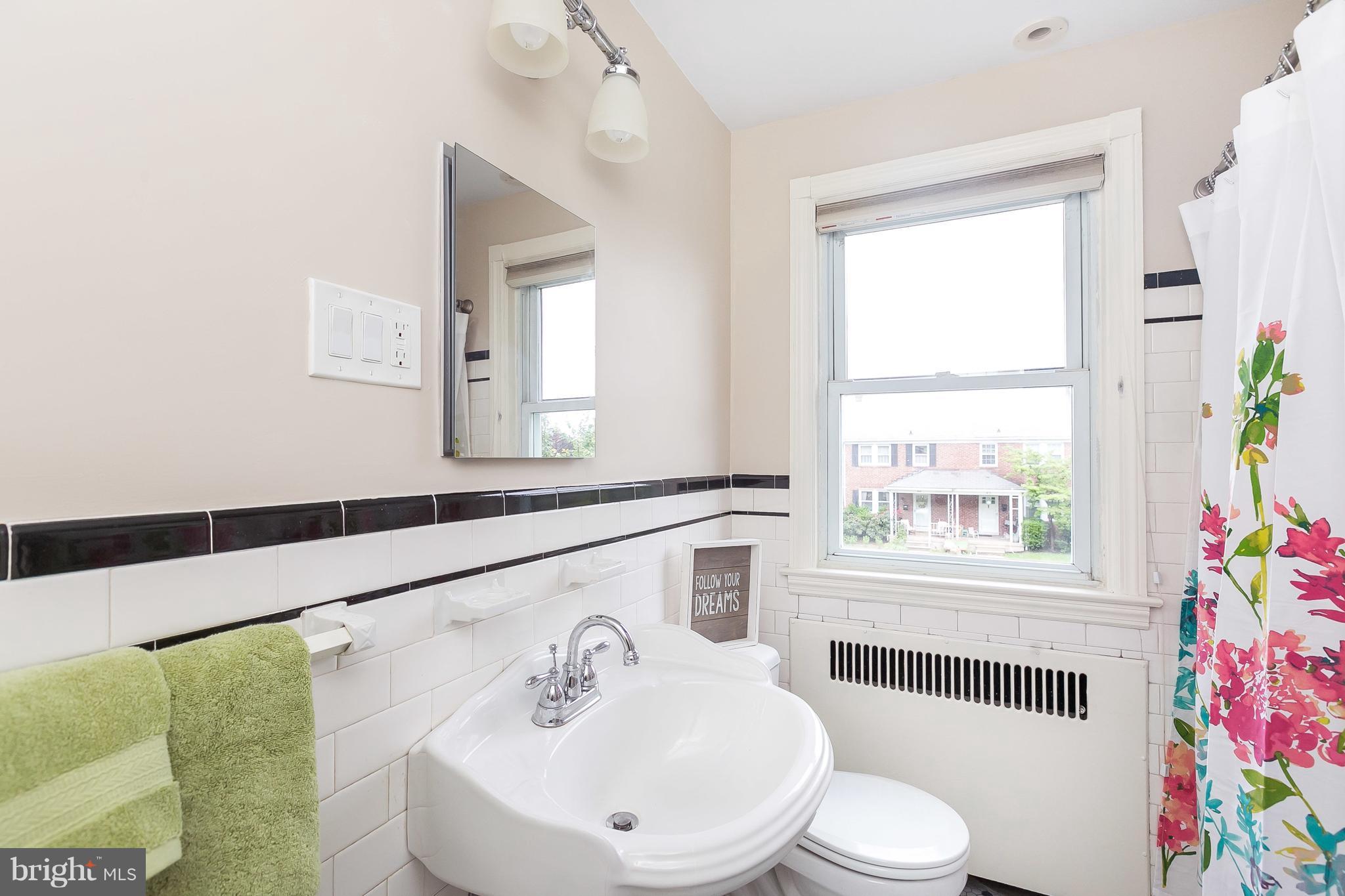 39 Murdock Road Baltimore, MD 21212 - Photo 21 of 28 a bathroom with a sink mirror vanity and toilet