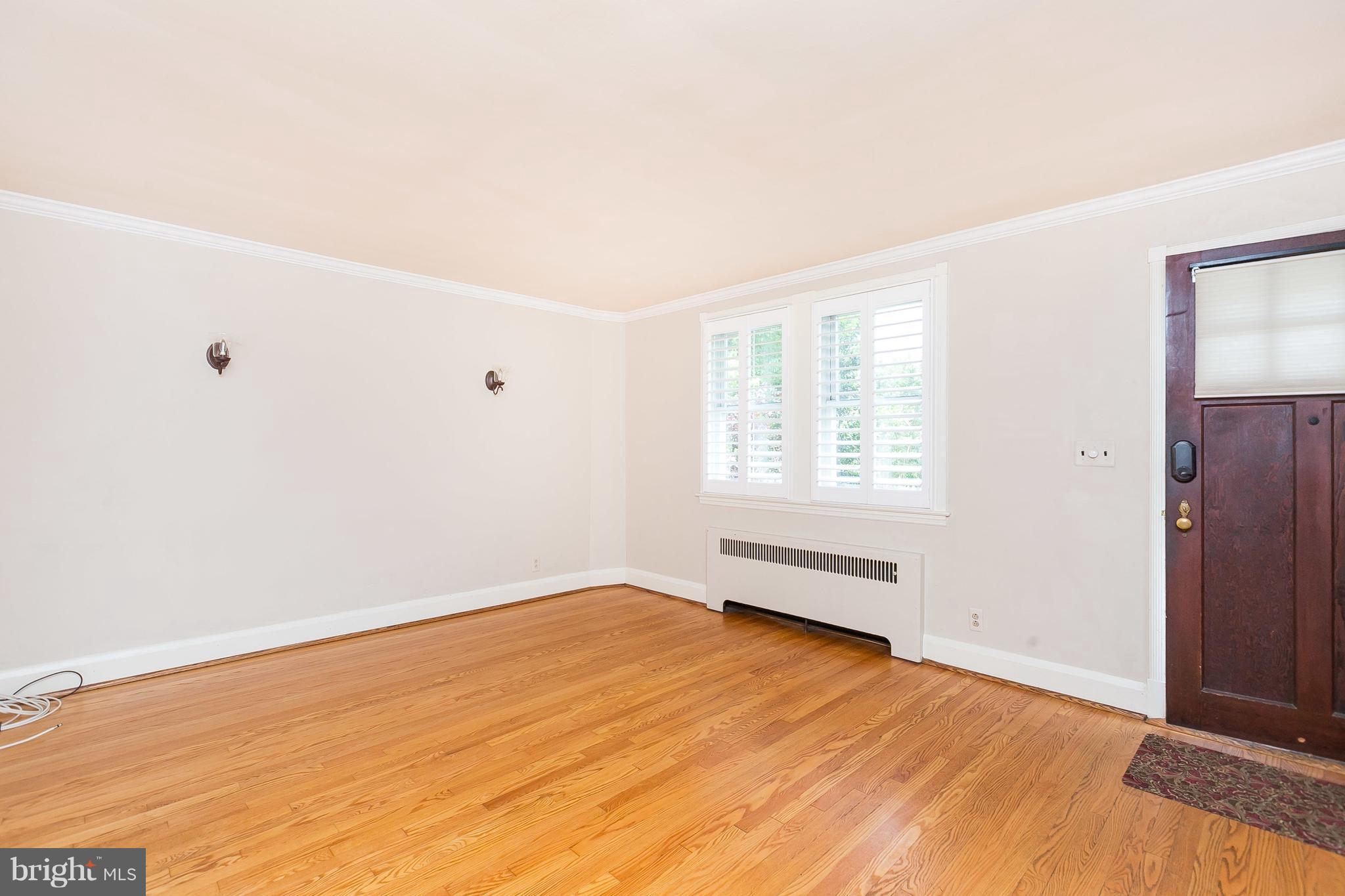 39 Murdock Road Baltimore, MD 21212 - Photo 6 of 28 an empty room with wooden floor and windows