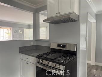 2293 Grand Long Beach, CA 90815 - Photo 3 of 7 a kitchen with granite countertop a stove and a white cabinets