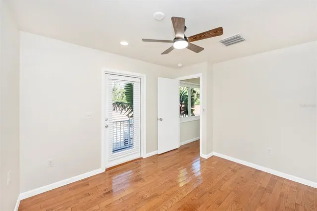 a view of a big room with wooden floor closet and windows