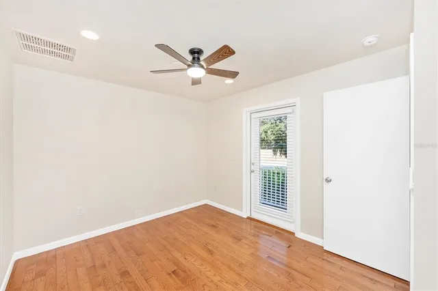 a view of a room with a window and a ceiling fan