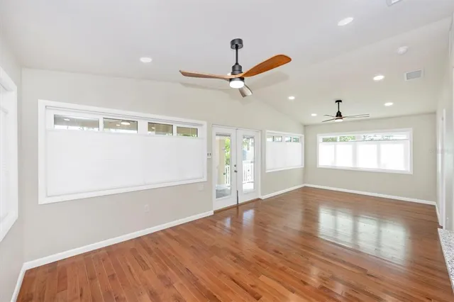 a view of an entryway with wooden floor and a kitchen