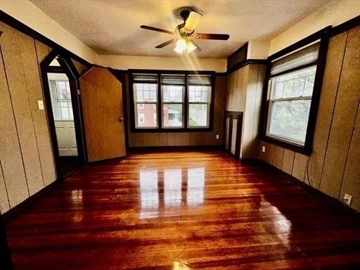 59 14th Avenue, Unit 2 Haverhill, MA 01830 - Photo 2 of 11 a view of an empty room with window and wooden floor