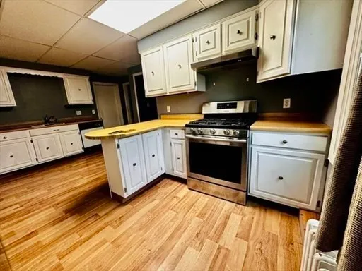 a kitchen with stainless steel appliances granite countertop a stove and a microwave