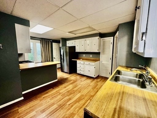 59 14th Avenue, Unit 2 Haverhill, MA 01830 - Photo 5 of 11 a kitchen that has a sink and a stove