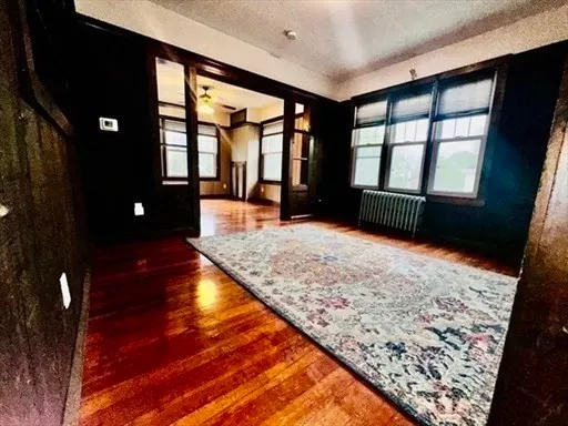 wooden floor in an empty room with a window